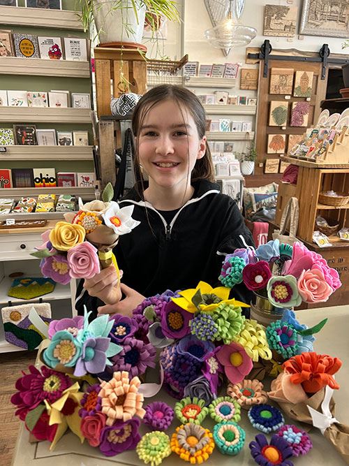 Josie surrounded by felt flowers